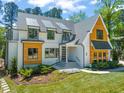 Charming two-story home with a modern farmhouse design and manicured lawn at 1616 Hunting Ridge Rd, Raleigh, NC 27615