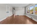 Sunlit living room features stylish flooring and neutral walls, offering a bright and inviting space at 1802 Prince Edward Dr, Elon, NC 27244