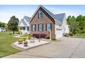 Charming two-story home featuring a landscaped yard, brick accents, and a side-entry two car garage at 192 Ash Lily Ct, Nashville, NC 27856