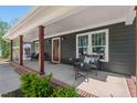 Inviting covered front porch features stylish seating and charming curb appeal, great for relaxing at 2019 James St, Durham, NC 27707