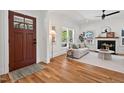 Bright living room with hardwood floors, fireplace, and a view of the front door creates an inviting space at 2019 James St, Durham, NC 27707
