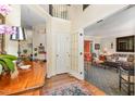Welcoming foyer with hardwood floors, a vintage table, and an arched doorway to the living room at 205 Lippershey Ct, Cary, NC 27513