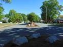 Scenic street view with mature trees, manicured landscaping, and single-Gathering homes at 223 S Main St, Wendell, NC 27591