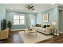 Bright living room featuring hardwood floors, neutral decor, and a ceiling fan for added comfort at 226 Mahogany Run, Raleigh, NC 27610