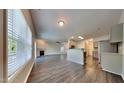 Open-concept living room with wood floors, fireplace, and seamless flow to the updated kitchen at 2428 Diquedo Dr, Raleigh, NC 27604