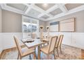 Formal dining room with coffered ceiling, elegant decor, and natural light at 2437 Terri Creek Dr, Fuquay Varina, NC 27526