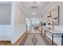 Inviting foyer showcasing wood floors, paneled walls, and an open view into the home at 2437 Terri Creek Dr, Fuquay Varina, NC 27526