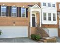 Front exterior of a brick townhome featuring an attached garage and an inviting front entrance at 2507 Princewood St, Raleigh, NC 27612
