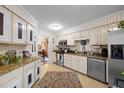 Bright kitchen with stainless appliances, striped walls and eat-in dining area at 3100 Coachmans Way, Durham, NC 27705