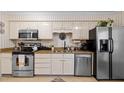Spacious kitchen featuring granite countertops, stainless appliances, and ample cabinet space at 3100 Coachmans Way, Durham, NC 27705