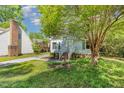 Cozy home featuring brick chimney, bay window, and mature shade trees at 3109 E Folkestone Pl, Raleigh, NC 27604