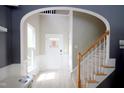 Bright foyer features an arched doorway, staircase, and a front door decorated for Easter at 3219 Ranbir Dr, Durham, NC 27713