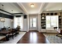 Open-concept entryway featuring hardwood floors, custom shelving, and elegant dining area at 33 Blackhorn Ct, Pittsboro, NC 27312