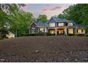 Charming two-story home with stone and siding exterior, a well-manicured lawn, and a lovely side house at 3513 Forest Oaks Dr, Chapel Hill, NC 27514