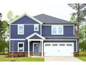 Charming two-story home with a craftsman style and a well-maintained front lawn at 3813 Rosebush Dr, Zebulon, NC 27597