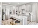 Modern kitchen with stainless steel appliances, ample cabinetry, a center island, and stylish stools at 3813 Rosebush Dr, Zebulon, NC 27597