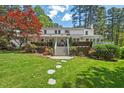 Expansive backyard featuring a large deck, lush lawn, and stepping stone pathway at 3826 Regent Rd, Durham, NC 27707
