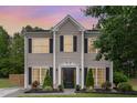 Charming two-story home with a well-manicured lawn and beautiful landscaping at 406 Sapphire Dr, Durham, NC 27703