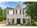 Charming two-story home with meticulously landscaped front yard and black accents at 406 Sapphire Dr, Durham, NC 27703