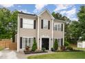 Charming two-story home with meticulously landscaped front yard and black accents at 406 Sapphire Dr, Durham, NC 27703