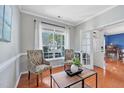 Bright and airy living room with two accent chairs, hardwood floors, and natural lighting at 421 Gooseberry Dr, Holly Springs, NC 27540