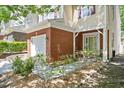 Home exterior featuring brick accents, covered entrance with white columns, and a one-car garage at 4240 Camden Woods Ct, Raleigh, NC 27612