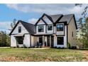 Beautifully built modern farmhouse with black framed windows and a lush green lawn at 45 Hamilton Way, Youngsville, NC 27596