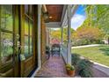 Inviting front porch with brick flooring and comfortable seating, perfect for relaxation at 4513 Touchstone Forest Rd, Raleigh, NC 27612