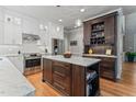 Modern kitchen with stainless steel appliances, a center island with a marble countertop, and ample storage at 4513 Touchstone Forest Rd, Raleigh, NC 27612