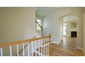 Inviting entryway featuring wood stairs, white railing and luxury vinyl plank flooring at 4517 Pale Moss Dr, Raleigh, NC 27606