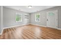 Bright living room with wood floors, fresh paint, and two windows offering natural light at 508 Solar Dr, Raleigh, NC 27610