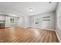Open-concept space with wood floors, access to the kitchen, and neutral paint throughout at 508 Solar Dr, Raleigh, NC 27610