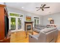 Bright living room featuring hardwood floors, fireplace, and access to outdoor space at 511 Hillsborough St # 103, Chapel Hill, NC 27514