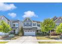 Beautiful two-story home with professional landscaping, two-car garage and a vibrant green lawn at 512 Flip Trl, Cary, NC 27513