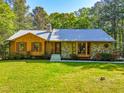 Attractive home featuring a mix of stone and wood siding, complemented by a green lawn at 5204 William And Mary, Raleigh, NC 27616