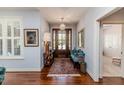 Bright foyer featuring hardwood floors, stylish lighting, and a glimpse of a bedroom at 524 Auguston Ct, Sanford, NC 27330