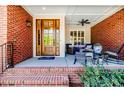 Inviting front porch with brick columns, rocking chairs, and decorative 