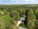 Aerial view of property with a pool surrounded by lush, mature trees at 524 Birdsong Ln, Hurdle Mills, NC 27541