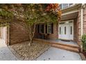 Welcoming front entrance with double doors, seating area, and beautiful landscaping at 524 Birdsong Ln, Hurdle Mills, NC 27541