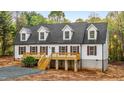Charming home featuring a covered porch, white siding, a dark gray roof and meticulous landscaping at 580 Greenbriar Farm Trl, Siler City, NC 27344
