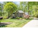Beautiful brick home with manicured lawn and landscaping with mature trees at 5912 Weather Rock Ct, Raleigh, NC 27613