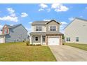 Traditional two-story home with vinyl siding, a one car garage and well-manicured lawn at 632 Hunters Ridge Dr, Fuquay Varina, NC 27526