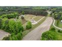 Scenic aerial view of a charming homes nestled among lush trees, neighboring farm fields and quiet roads at 66 Privette Way, Zebulon, NC 27597