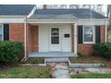 Close-up of the home's front door and facade detailing brick and architectural features at 704 N King Charles Rd, Raleigh, NC 27610