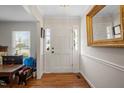 Bright foyer featuring hardwood floors, a white front door, and a gold mirror at 705 N Gurney St, Burlington, NC 27215