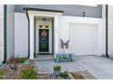 Inviting front entrance with a decorative wreath, charming bench, and a well-lit doorway at 713 Putney Hill Rd, Zebulon, NC 27597