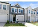 Beautiful townhome exterior with stone accents, an attached garage, and a lovely front garden at 713 Putney Hill Rd, Zebulon, NC 27597