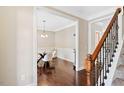 Elegant dining room showcasing hardwood floors, wainscoting, and stylish lighting fixture at 80 Cullen Ct, Franklinton, NC 27525