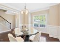 Bright dining room features modern decor and large windows overlooking the yard at 80 Cullen Ct, Franklinton, NC 27525