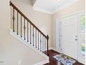 Bright foyer with hardwood floors, staircase with iron spindles, and natural light at 80 Cullen Ct, Franklinton, NC 27525